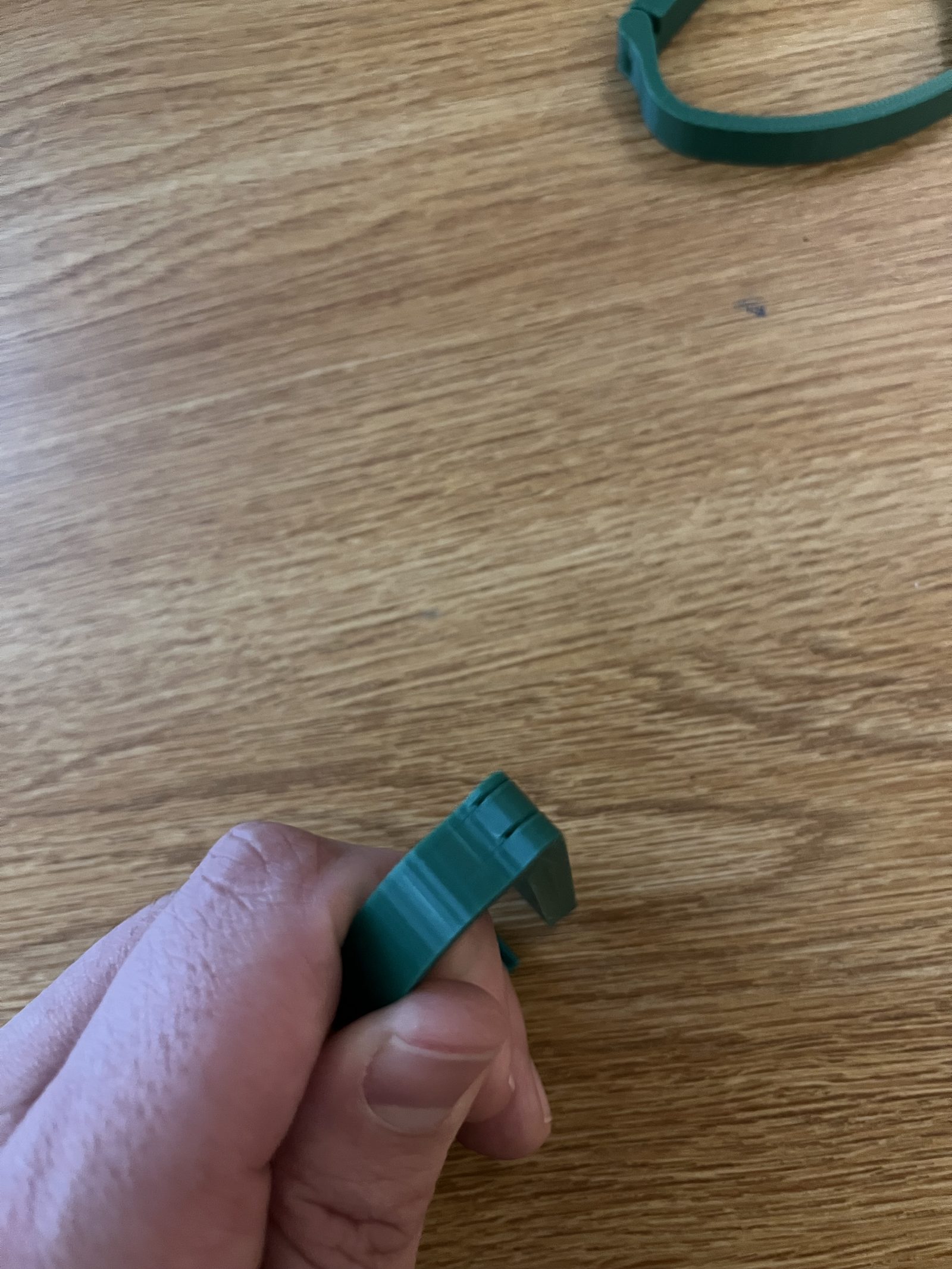Third capo prototype held in hand, with the hinge fused shut